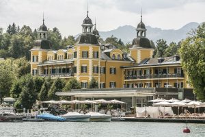 Das Falkensteiner Schlosshotel Velden zieht mit seiner farbenfrohen Fassade und den vier Türmen alle Blicke auf sich.